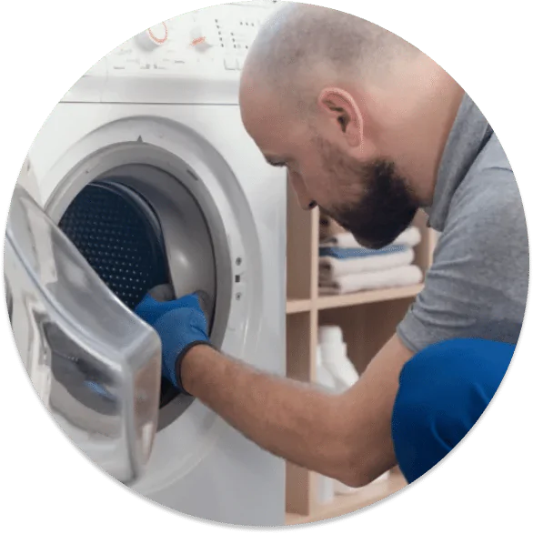 A contractor fixing a laundry machine